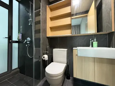 a bathroom with a toilet and a sink and a shower at The Luxe & The Colony Infinitum by Romeo Bnb in Kuala Lumpur
