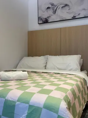 a bedroom with a bed with a checkered blanket at The Luxe & The Colony Infinitum by Romeo Bnb in Kuala Lumpur