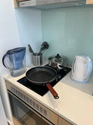 a frying pan on top of a stove in a kitchen at The Luxe & The Colony Infinitum by Romeo Bnb in Kuala Lumpur