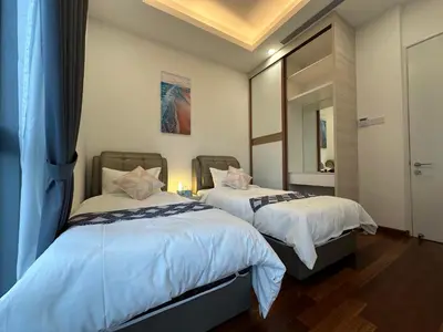 a bedroom with two beds and a mirror at Royce Residences by Romeo Bnb in Kuala Lumpur