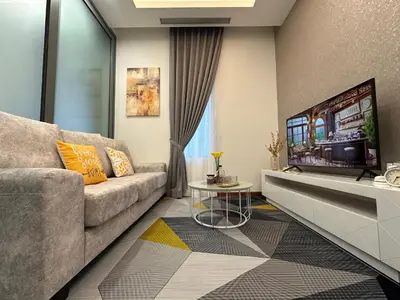 a living room with a couch and a tv at Royce Residences by Romeo Bnb in Kuala Lumpur
