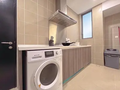 a washing machine in a bathroom with a counter at D'Rapport Residences by Manhattan Group in Kuala Lumpur