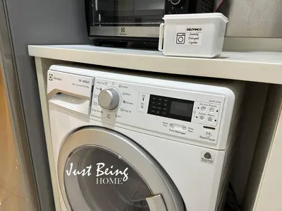 a washing machine with a microwave on top of it at Just Being Home 5pax 1BR/1BA 1Queen/1Single/1Sofa in Kuala Lumpur