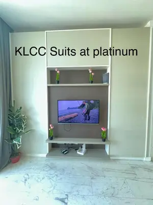 a tv sitting on a shelf in a room at KLCC Suites at Platinum in Kuala Lumpur