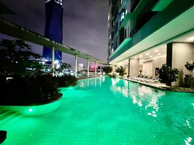 a large swimming pool in a building at night at Casa Residency Service Apartment By Moonlight in Kuala Lumpur