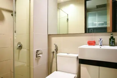 a bathroom with a toilet and a sink and a mirror at Casa Residency Service Apartment By Moonlight in Kuala Lumpur