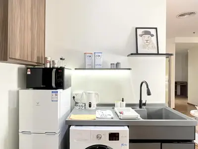 a kitchen with a sink and a dishwasher at The Latrobe - Bangsar Trade Centre in Kuala Lumpur