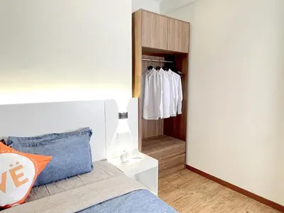 a bedroom with a bed and a closet at The Latrobe - Bangsar Trade Centre in Kuala Lumpur
