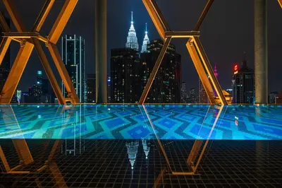 a view of a swimming pool at night at Scarletz Suites KLCC by KAN's in Kuala Lumpur