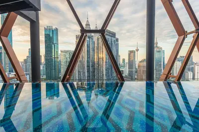 a swimming pool with a view of a city skyline at Scarletz Suites KLCC by KAN's in Kuala Lumpur
