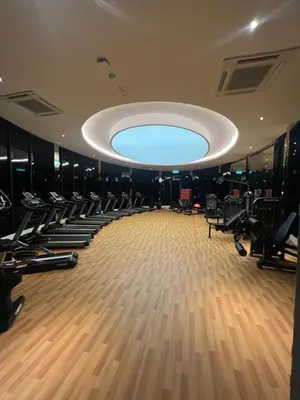 a gym with rows of tread machines and a large ceiling at Skyscraper 65 KL Highest Outdoor Bathtub Luxury Lavish Designer Suite Penthouse Lv65 in Kuala Lumpur