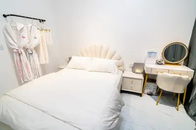 a bedroom with a bed and a vanity and a mirror at Skyscraper 65 KL Highest Outdoor Bathtub Luxury Lavish Designer Suite Penthouse Lv65 in Kuala Lumpur