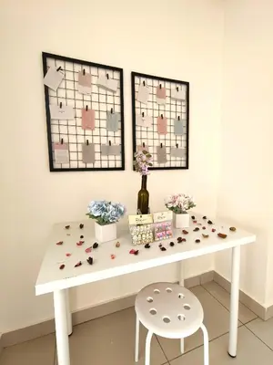a white table with flowers on it with two windows at KLCC VIEW Setapak Homestay 2BR KL view 8pax 15 min to KLCC PV21A R in Kuala Lumpur