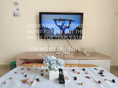 a room with a tv and a bed with shells at KLCC VIEW Setapak Homestay 2BR KL view 8pax 15 min to KLCC PV21A R in Kuala Lumpur