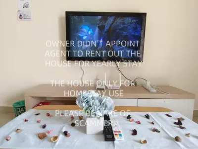 a tv screen with a sign on a bed with shells at KLCC VIEW Setapak Homestay 2BR KL view 8pax 15 min to KLCC PV21A R in Kuala Lumpur