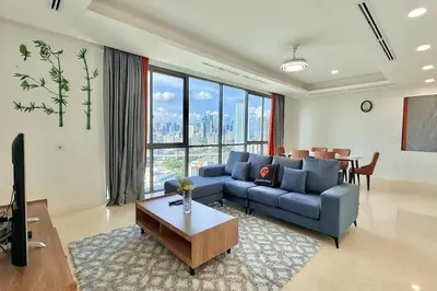 a living room with a blue couch and a table at D'Rapport Residence KL by manatidur in Kuala Lumpur