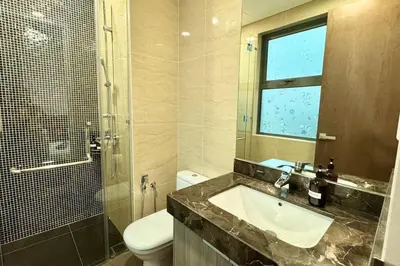 a bathroom with a sink and a toilet and a window at D'Rapport Residence KL by manatidur in Kuala Lumpur