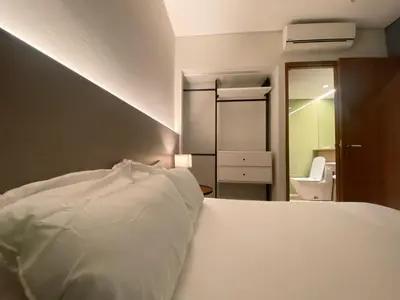 a bedroom with a white bed and a bathroom at Sky Suites & Residence KLCC Kuala Lumpur in Kuala Lumpur