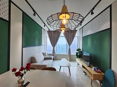 a living room with a table and a large window at Sky Suites & Residence KLCC Kuala Lumpur in Kuala Lumpur