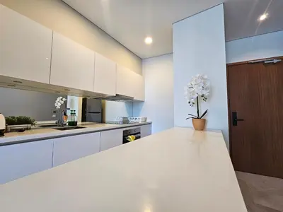 a kitchen with white cabinets and a white counter top at Sky Suites & Residence KLCC Kuala Lumpur in Kuala Lumpur