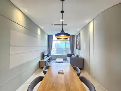 a conference room with a long wooden table and chairs at Sky Suites & Residence KLCC Kuala Lumpur in Kuala Lumpur