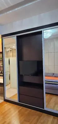 a large entertainment center with a television in a room at Dorsett Bukit Bintang in Kuala Lumpur