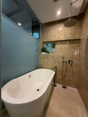 a large white tub in a bathroom with a shower at Dorsett Bukit Bintang in Kuala Lumpur
