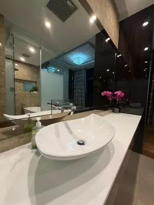 a bathroom with a sink and a large mirror at Dorsett Bukit Bintang in Kuala Lumpur
