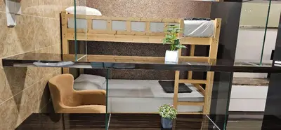 a glass table in a room with a bunk bed at Dorsett Bukit Bintang in Kuala Lumpur