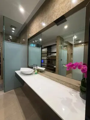 a bathroom with a sink and a large mirror at Dorsett Bukit Bintang in Kuala Lumpur