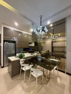 a large kitchen with a dining table and chairs at Dorsett Bukit Bintang in Kuala Lumpur