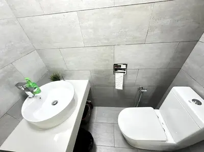 a bathroom with a white sink and a toilet at Simple Arte Mont Kiara 1B1B 4 Pax Mitec Matrade in Kuala Lumpur