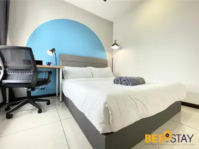 a bedroom with a bed and a desk and a chair at Balcony KLCC View Kampung Baru Luxurious in Kuala Lumpur