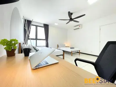 a living room with a table with a laptop on it at Balcony KLCC View Kampung Baru Luxurious in Kuala Lumpur