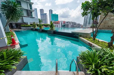 a swimming pool with blue water in a city at No Other Fee #Swiss Garden Residences by The Boston House #Bukit Bintang in Kuala Lumpur