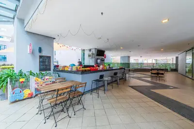 a restaurant with a counter and tables and chairs at No Other Fee #Swiss Garden Residences by The Boston House #Bukit Bintang in Kuala Lumpur