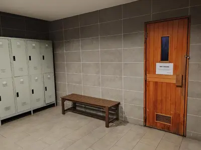 a bench in a locker room with a door and lockers at No Other Fee #Swiss Garden Residences by The Boston House #Bukit Bintang in Kuala Lumpur