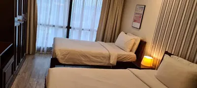 a hotel room with two beds and a window at Raymond Suites at Times Square kuala Lumpur in Kuala Lumpur