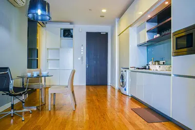 a kitchen with a table and a dining room at SKYWARD SUITES at Platinum KLCC in Kuala Lumpur