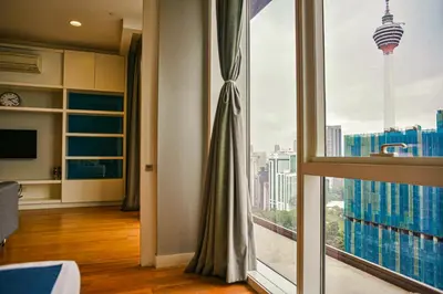 a room with a large window with a view of a city at SKYWARD SUITES at Platinum KLCC in Kuala Lumpur