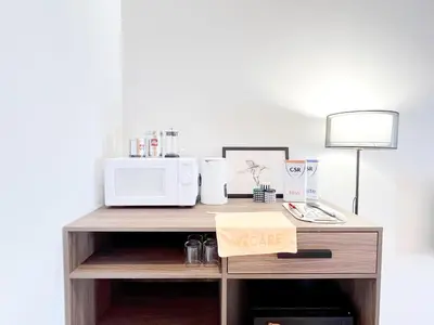 a desk with a microwave and a sign on it at The Lonsdale - Bangsar Trade Centre in Kuala Lumpur