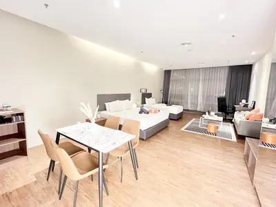 a living room with a dining table and a couch at The Bourke - Bangsar Trade Centre in Kuala Lumpur
