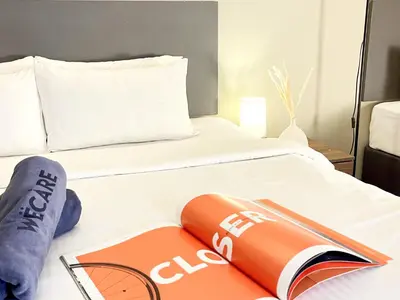a bed with an open book on top of it at The Bourke - Bangsar Trade Centre in Kuala Lumpur