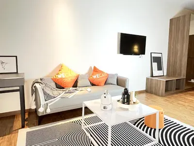 a living room with a couch and a table at The Bourke - Bangsar Trade Centre in Kuala Lumpur