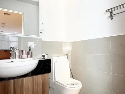 a bathroom with a white sink and a toilet at The Collins - Bangsar Trade Centre in Kuala Lumpur
