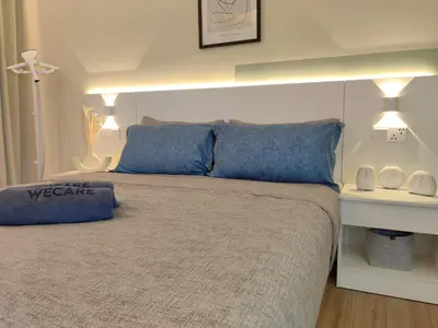 a bedroom with a large bed with blue pillows at The Tranquil - Bangsar Trade Centre in Kuala Lumpur