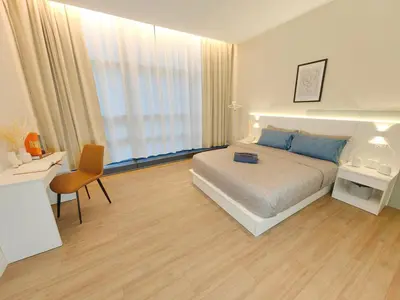 a bedroom with a bed and a desk and a chair at The Tranquil - Bangsar Trade Centre in Kuala Lumpur