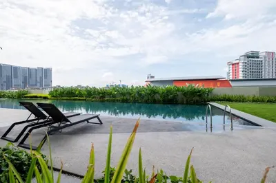 a couple of chairs sitting next to a pool of water at UNA Residence By Feel Home Malaysia opposite Sunway Velocity Mall in Kuala Lumpur