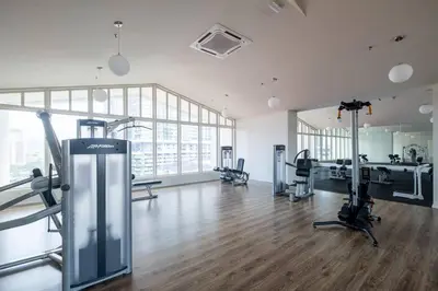 a gym with treadmills and exercise equipment in a building at UNA Residence By Feel Home Malaysia opposite Sunway Velocity Mall in Kuala Lumpur