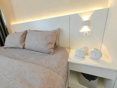 a bedroom with a bed and a desk with a mirror at The Ovation - Bangsar Trade Centre in Kuala Lumpur